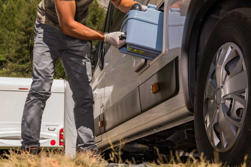 Mann entfernt Toilettenkassette aus seinem Wohnmobil